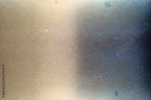 Blank grained film strip texture background with heavy grain, dust and light leak.
