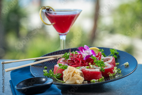 Tuna wrapped sushi roll with berry cocktail.