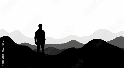 Silhouette of a lone man standing on a mountain peak.