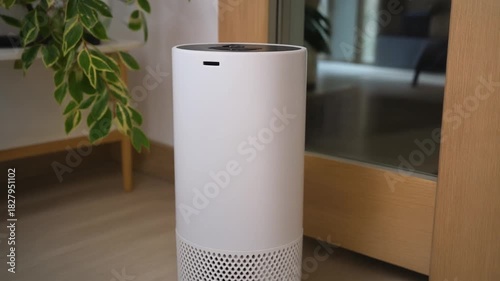 Modern white air purifier standing on a wooden floor, enhancing home air quality with advanced filtration technology and sleek design in a residential setting