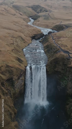 Dramatic view of Seljalandsfoss waterfall in Iceland, cascading over rugged cliffs into a misty basalt valley, showcasing raw Nordic nature and iconic travel scenery.