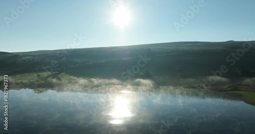 Sunrise over misty lake