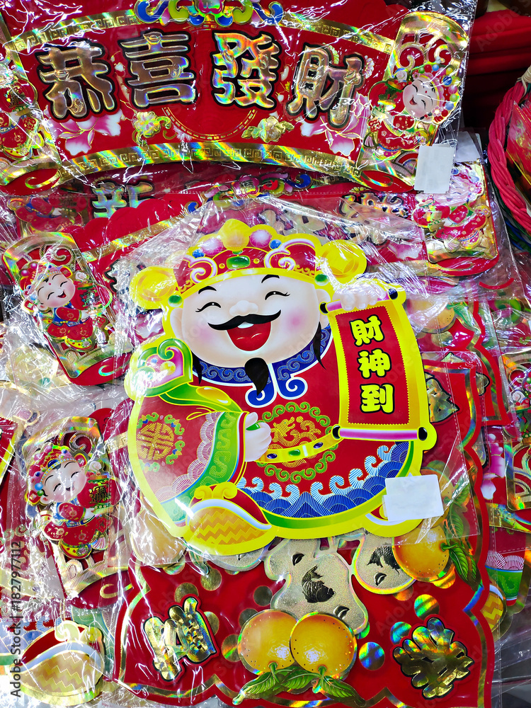 Fototapeta premium Chinese New Year decorations featuring the God of Wealth (Caishen). Translate : The God of Wealth Arrives, May you be happy and prosperous.