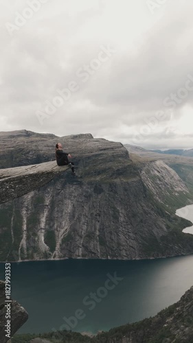 Trolltunga Overlook with Hiker Above Norwegian Fjord