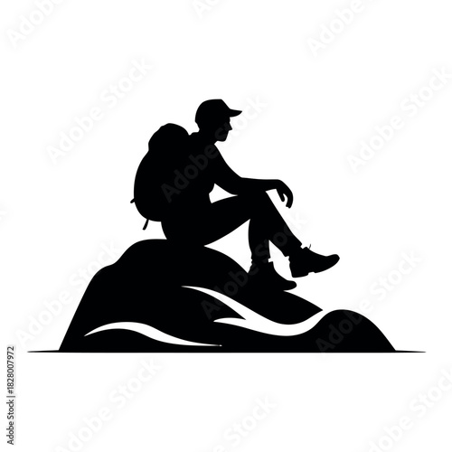 Silhouette of a hiker resting on a rocky summit