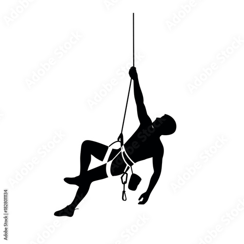 Silhouette of a rock climber suspended by a rope