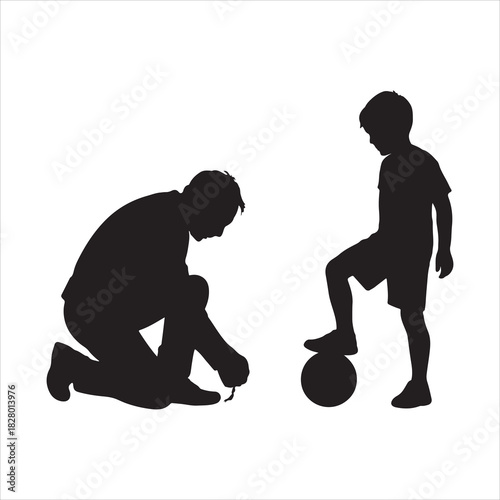 Father kneeling tying child's shoelace next to young boy with foot on soccer ball, preparing for play and sports activity for family