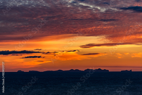Stunningly beautiful sunset over the ocean as seen from the cape cliffs near the lighthouse of Vik, small city in Southern Iceland, travel tourist destination and sightseeing