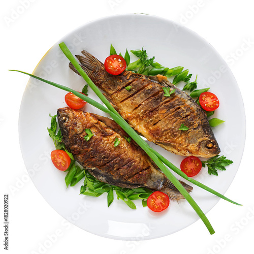 Delicious whole grilled fish served with fresh herbs and cherry tomatoes on a white plate