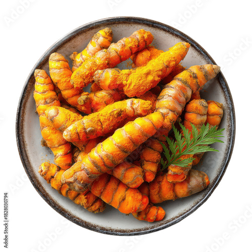 Pile of fresh turmeric roots with green sprig and cut slices on a gray plate on an isolated white background creating a bright and inviting scene for healthy food concept