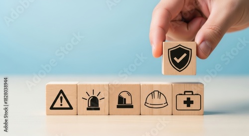 Hand places shield icon cube, emphasizing safety and protection.