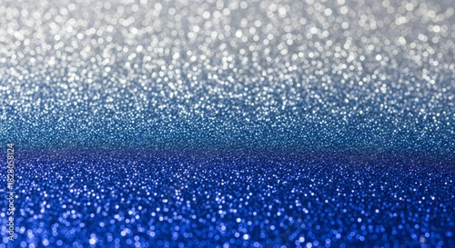 Sparkling Silver to Blue Christmas Glitter Gradient. abstract texture background featuring a smooth gradient of sparkling glitter, transitioning from shimmering silver at the top to deep festive blue
