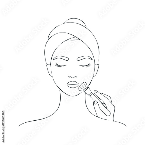 Woman applying makeup with brush woman wearing head towel applying foundation cosmetic beauty routine
