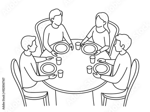 Four people sit around a round table set for a meal with plates and glasses.