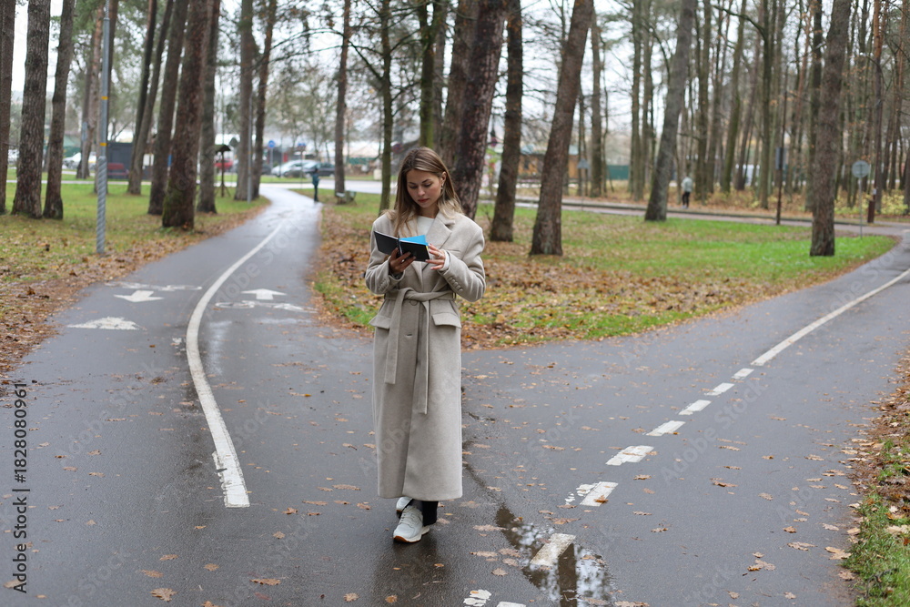 Fototapeta premium Woman Reading at a Fork in the Path
