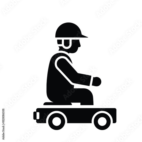 Black silhouette of person in hard hat on wheeled cart