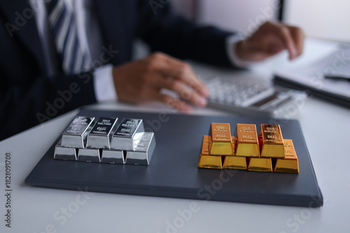 Businessman investing in precious metals gold and silver to diversify portfolios hedge against inflation and currency depreciation.