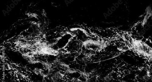 Splashes of water from the waves in the sea . splashes and flying drops of water on a dark background, bokeh defocused