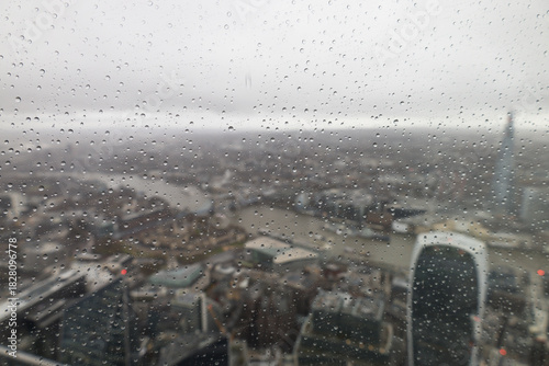 Blurred Cityscape of London with Raindrops on Glass