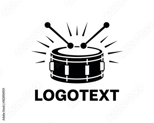 A black and white illustration of a drum with drumsticks above it, surrounded by radiating lines.
