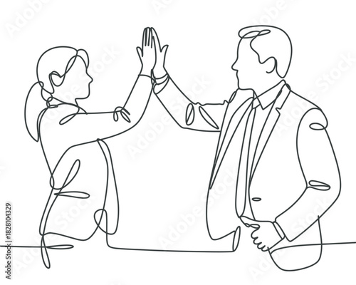 Two business professionals are giving each other a high five.