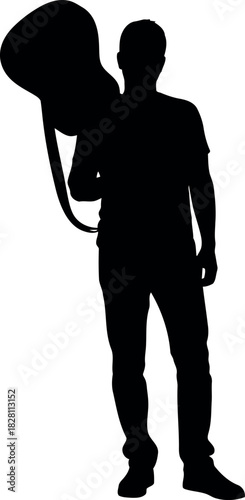 Male musician silhouette carrying acoustic guitar, artistic