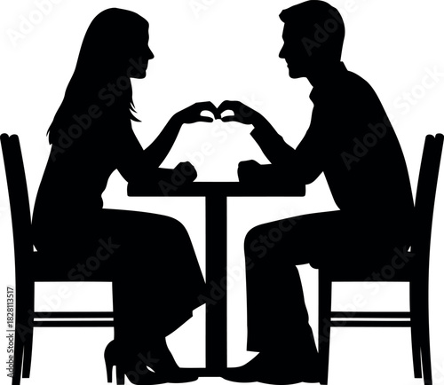 Couple making heart hand gesture at table, romantic silhouette
