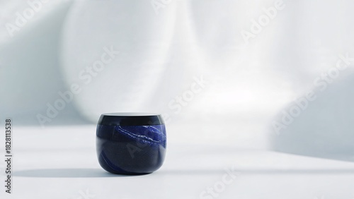 Elegant blue ceramic cup against soft white background with artistic lighting