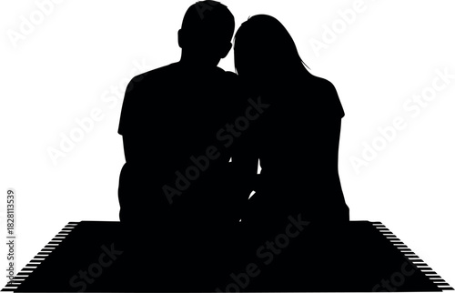Silhouetted couple sitting close on a mat, love and intimacy concept