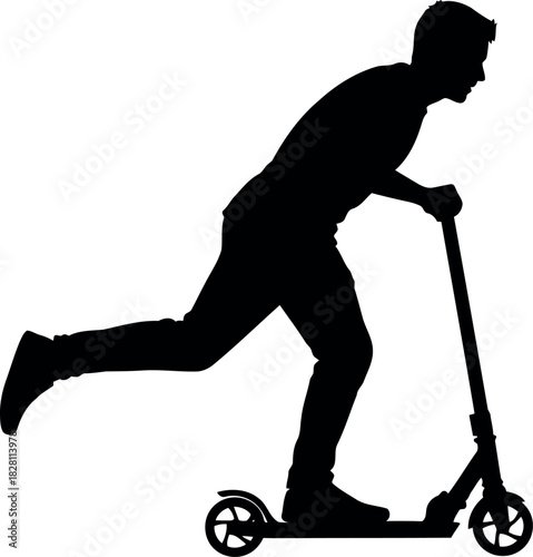 Silhouette of young man actively riding a kick scooter in motion.