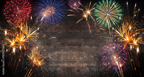 Christmas Fireworks Display on Wood Texture. Festive Background with Fireworks.

