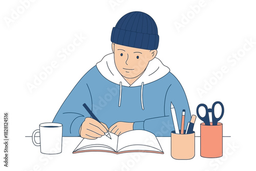A young person wearing a beanie and hoodie is writing in a notebook at a desk.