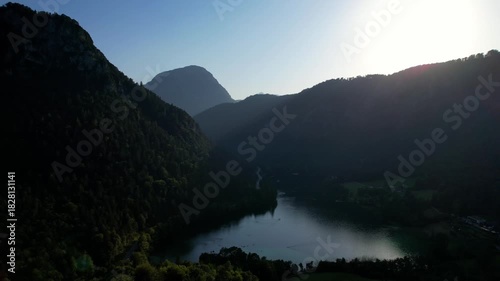 4K Aerial Drone video of Alpine lake Thumsee with turquoise water and lush green woods surrounded by tall mountains at sunset golden hour in Bad Reichenhall Germany