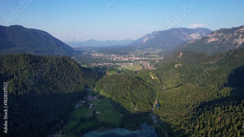 4K Aerial Drone video of Alpine lake Thumsee with turquoise water and lush green woods surrounded by tall mountains at sunset golden hour in Bad Reichenhall Germany