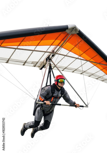 a young athlete in a dark grey flight suit and red helmet, dynamically suspended with a high-tension orange and black hang glider against a pure white studio background with copy space, concept for
