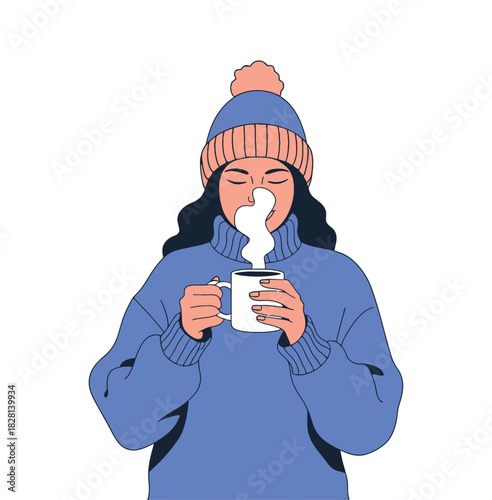 A person in a warm hat and sweater drinks a hot beverage.