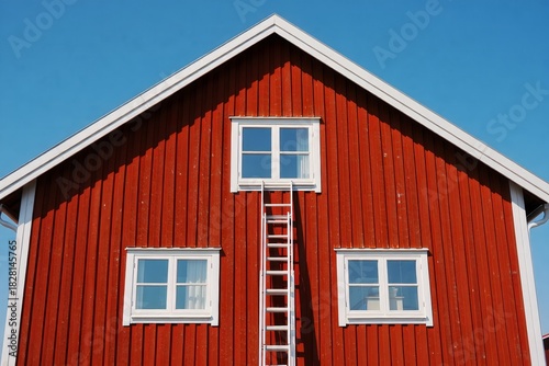 Red Barn Exterior with Ladder on Sunny Day