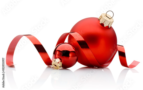 Two red Christmas baubles and curling paper ribbon isolated on white background