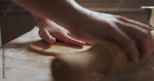 Housewife hands using cookie cutters to cut out Christmas cookies. Video with audio.