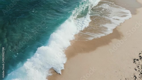 A tranquil coastal scene featuring gentle waves lapping against a pristine sandy beach. the crystal-clear turquoise water contrasts beautifully with the soft sand, creating a serene and peaceful atmos