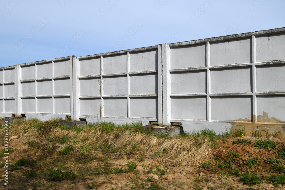 Obraz premium precast reinforced concrete fence consisting of individual panels,