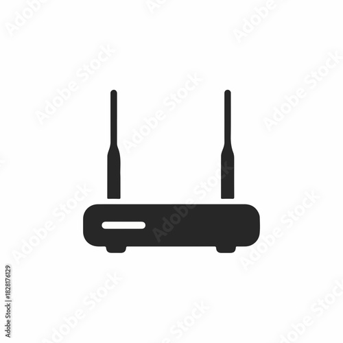 Black wireless router with antennas providing internet connection. Wireless router for homes provides reliable connectivity.