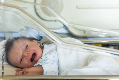 Photos Newborn baby crying feeling uncomfortable in a hospital bassinet
