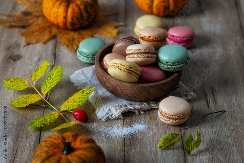 Macarons of different colors and flavors in a wooden bowl