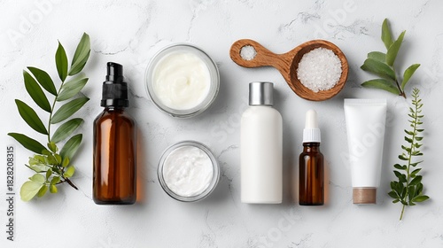 Natural Skincare Products with Green Leaves on White Marble Surface