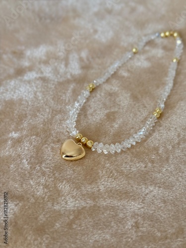 A golden heart. Hematite beads with shimmering triangular glass beads. Sparkling, jewelry-grade materials perfect for craft, design, and holiday themes