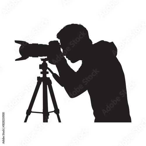 Silhouette of a photographer with a camera on a tripod