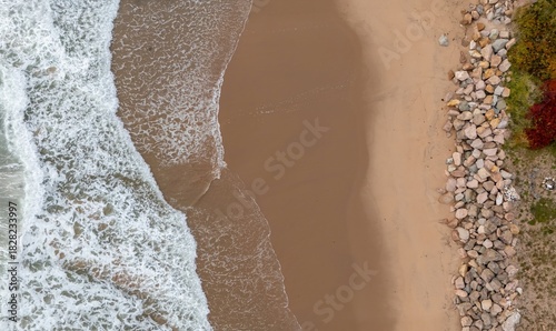 Top view of Ingonish Beach along Cabot Trail, Cape Breton, Nova Scotia, Canada. Incredible blue ocean waters with  the autumn fall foliage colors. 