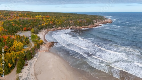 Ingonish Beach along Cabot Trail, Cape Breton, Nova Scotia, Canada. Incredible blue ocean waters with  the autumn fall foliage colors. 