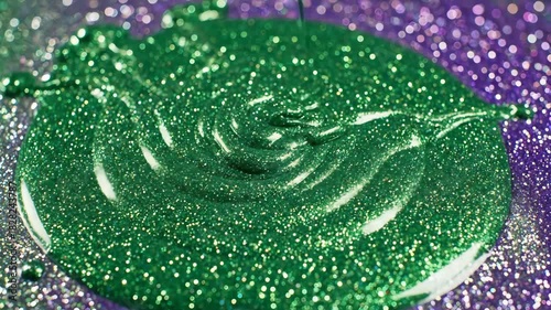 Captivating CloseUp Emerald Green Glitter Paint Pouring onto a Sparkling Surface Creating Mesmerizing Patterns and Textures in a Studio Setting Perfect for Abstract Art and Creative Projects.